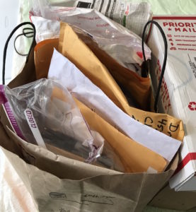 a bag filled with large envelopes of mail