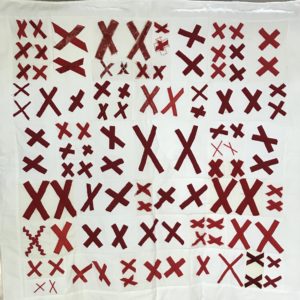 white quilt base covered with pairs of red X's