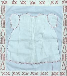 white baby christening gown sewn onto a white quit base, surrounded with pairs of red X's forming teardrops and streams of teardrops