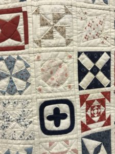 a closeup of small quilts sewn together to make a large quilt