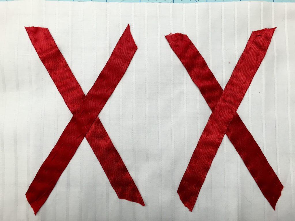 white cloth with two red X's on top