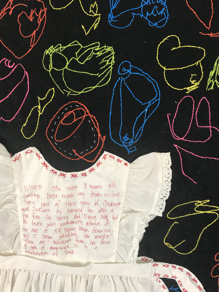 closeup of the white dress sewn onto a black quilt covered with colorful stitched scribbles