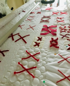 white cloth embellished with pairs of red X's