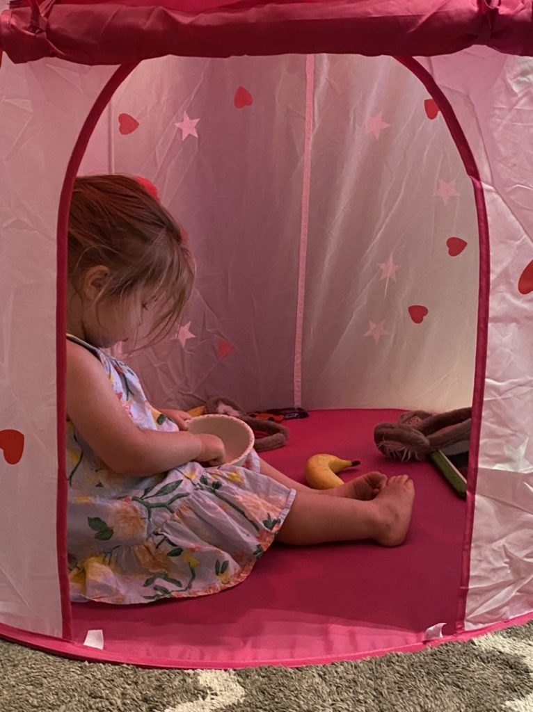 a young girl inside a tent